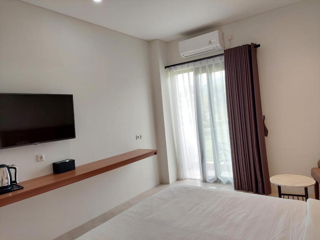 Postel nebo postele na pokoji v ubytování Gemma Hotel Balige