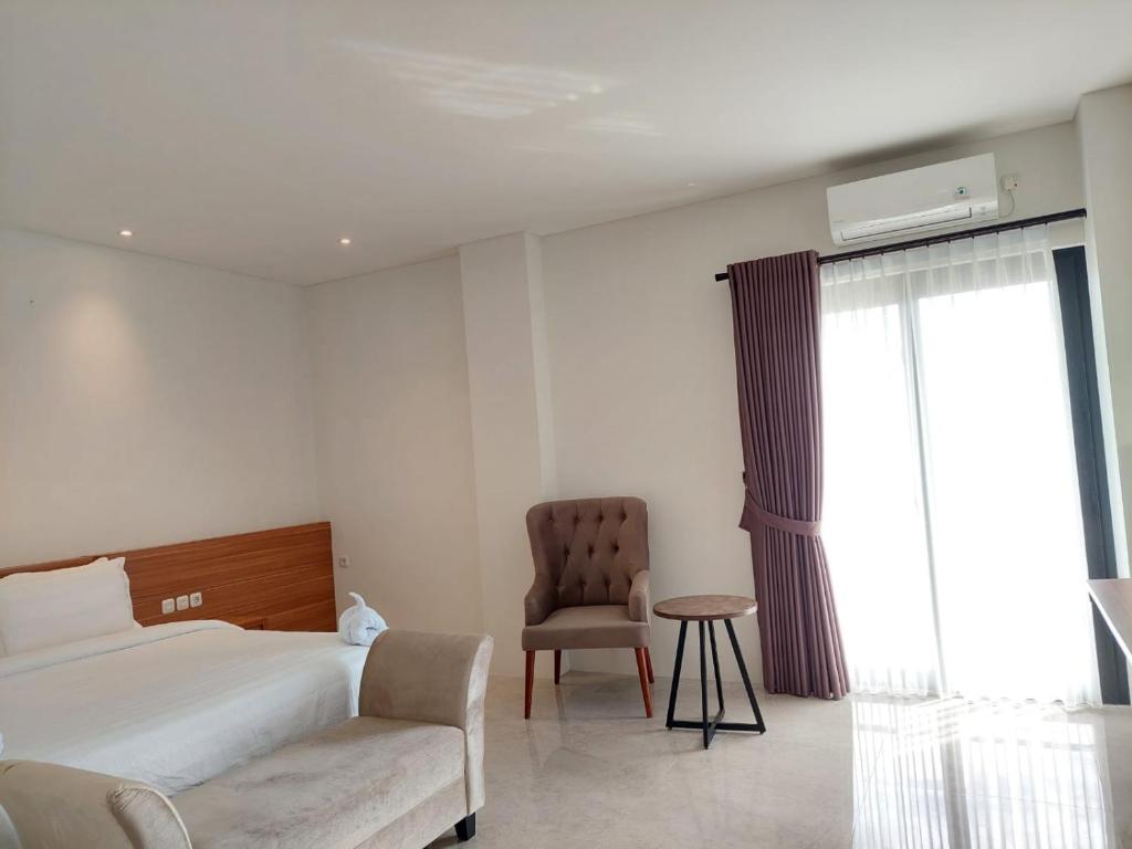 Postel nebo postele na pokoji v ubytování Gemma Hotel Balige