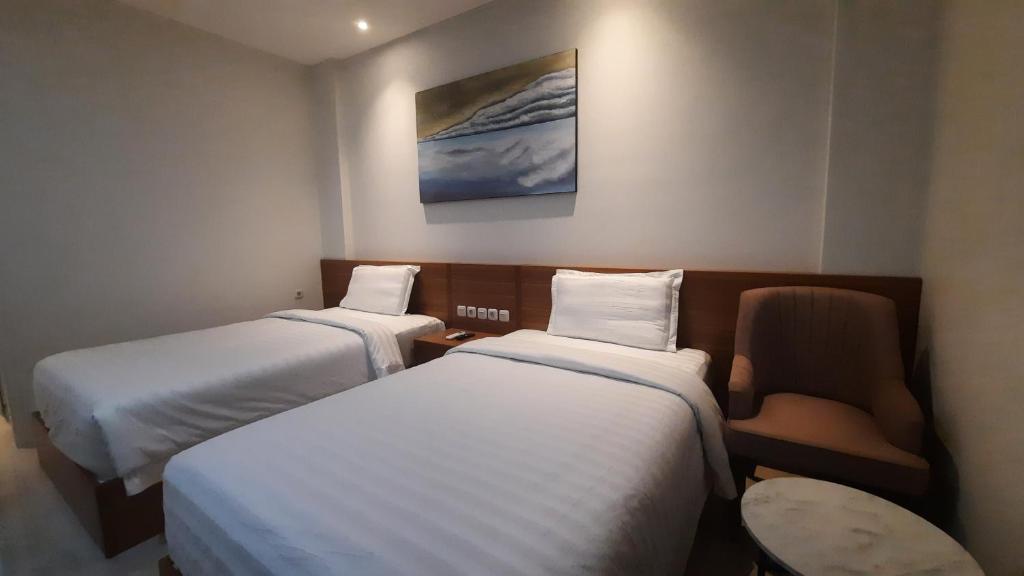 Postel nebo postele na pokoji v ubytování Gemma Hotel Balige