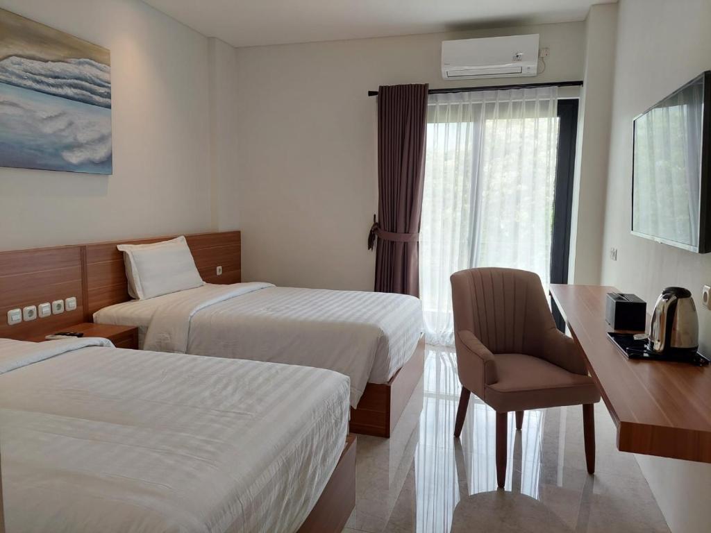 Postel nebo postele na pokoji v ubytování Gemma Hotel Balige
