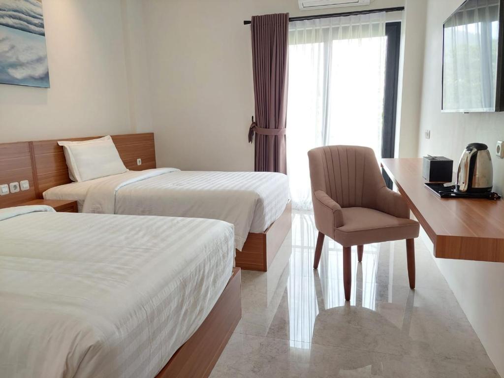 Postel nebo postele na pokoji v ubytování Gemma Hotel Balige