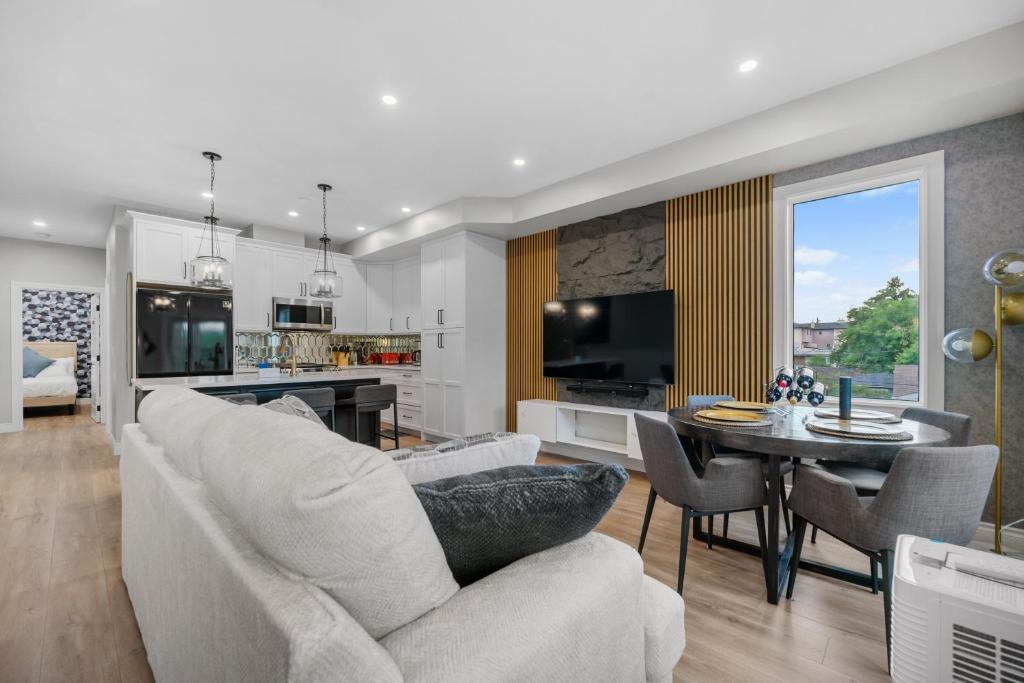a living room with a couch and a dining room at Casa Ladrillo - House of Bricks in Calgary