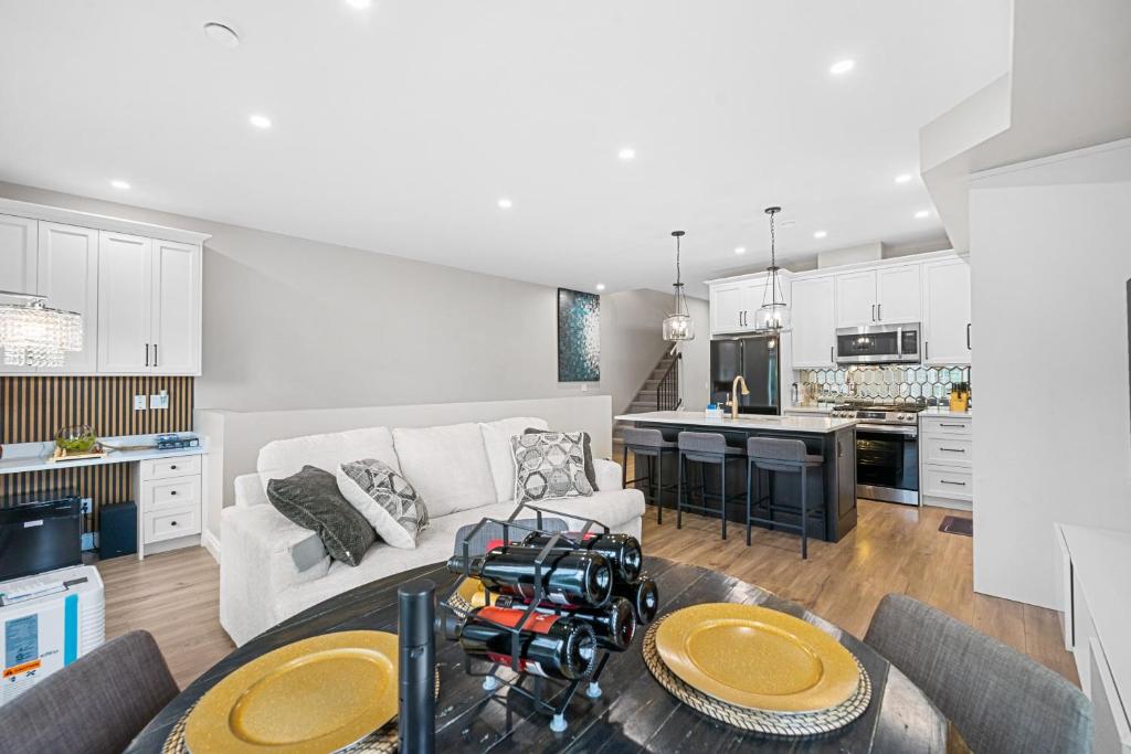 a living room and kitchen with a couch and a table at Casa Ladrillo - House of Bricks in Calgary