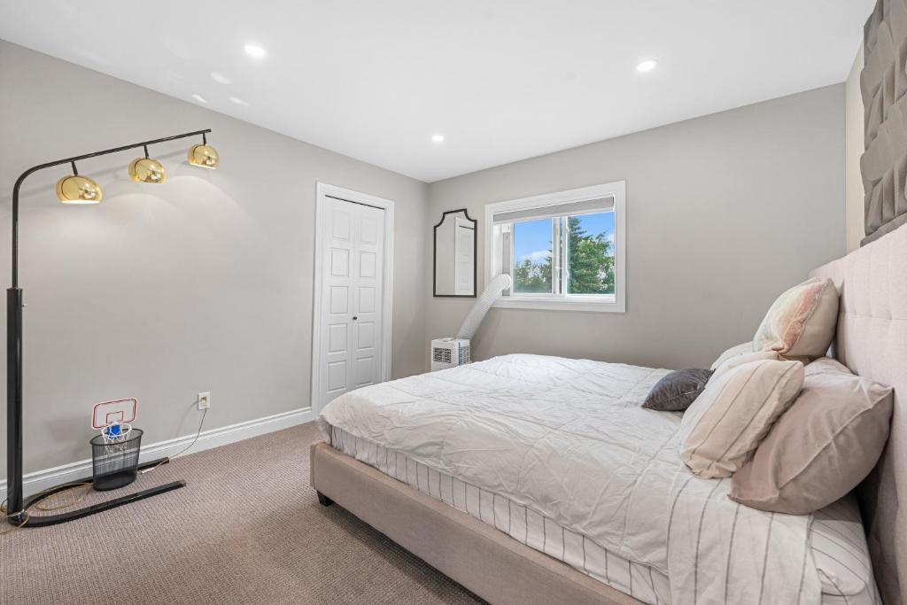 a bedroom with a large bed and a window at Casa Ladrillo - House of Bricks in Calgary