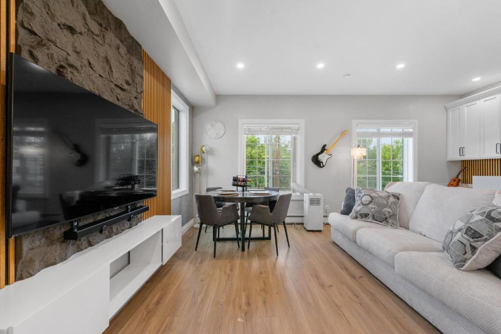a living room with a couch and a table at Casa Ladrillo - House of Bricks in Calgary
