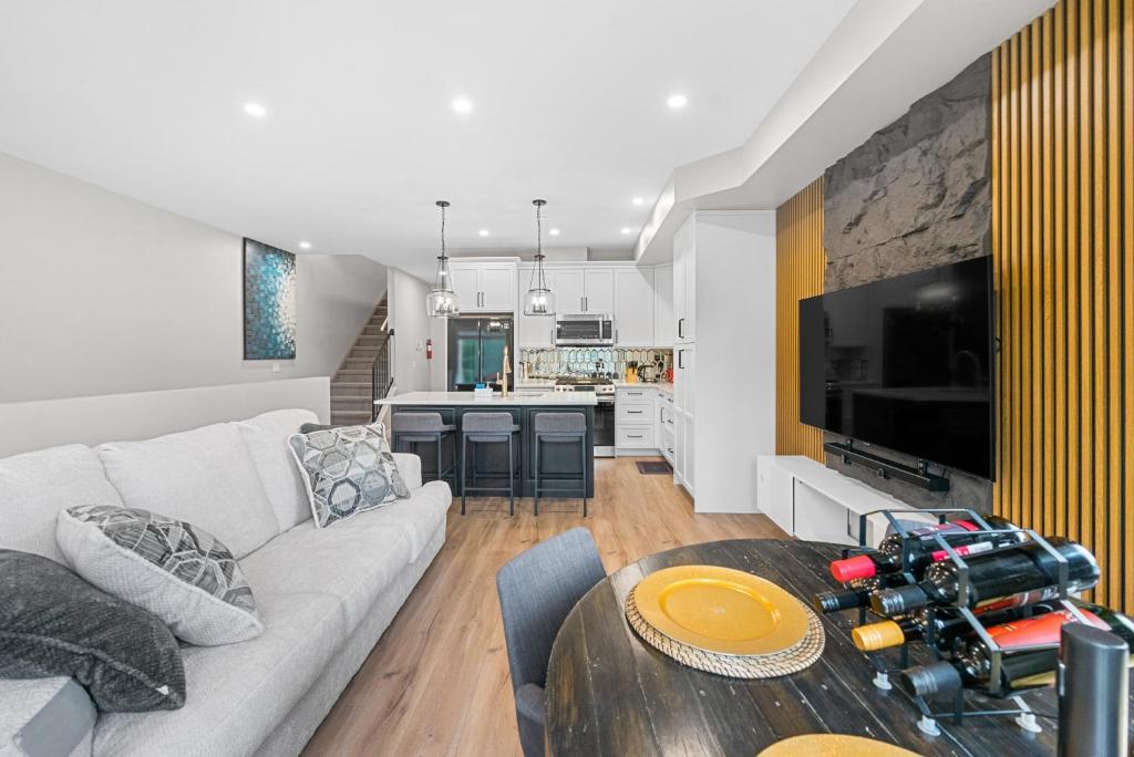 a living room with a white couch and a table at Casa Ladrillo - House of Bricks in Calgary