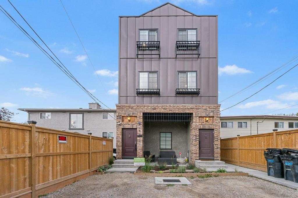a tall building with a fence in front of it at Casa Ladrillo - House of Bricks in Calgary
