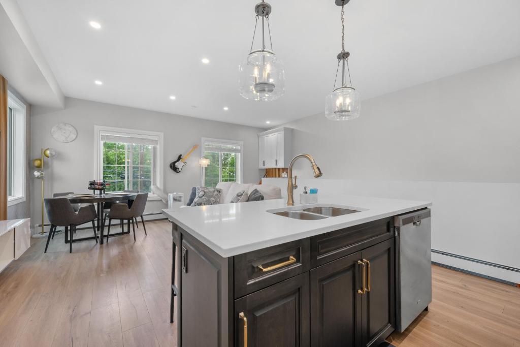 a kitchen with a sink and a table in it at Casa Ladrillo - House of Bricks in Calgary