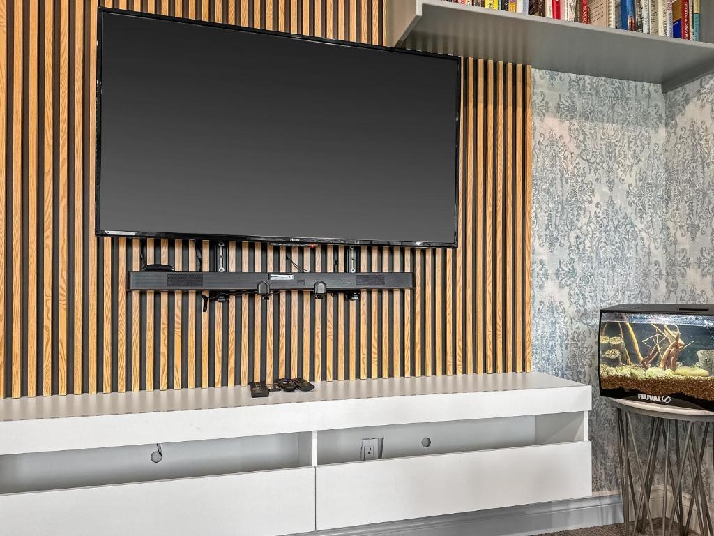 a flat screen tv hanging on a wall at Casa Ladrillo - House of Bricks in Calgary