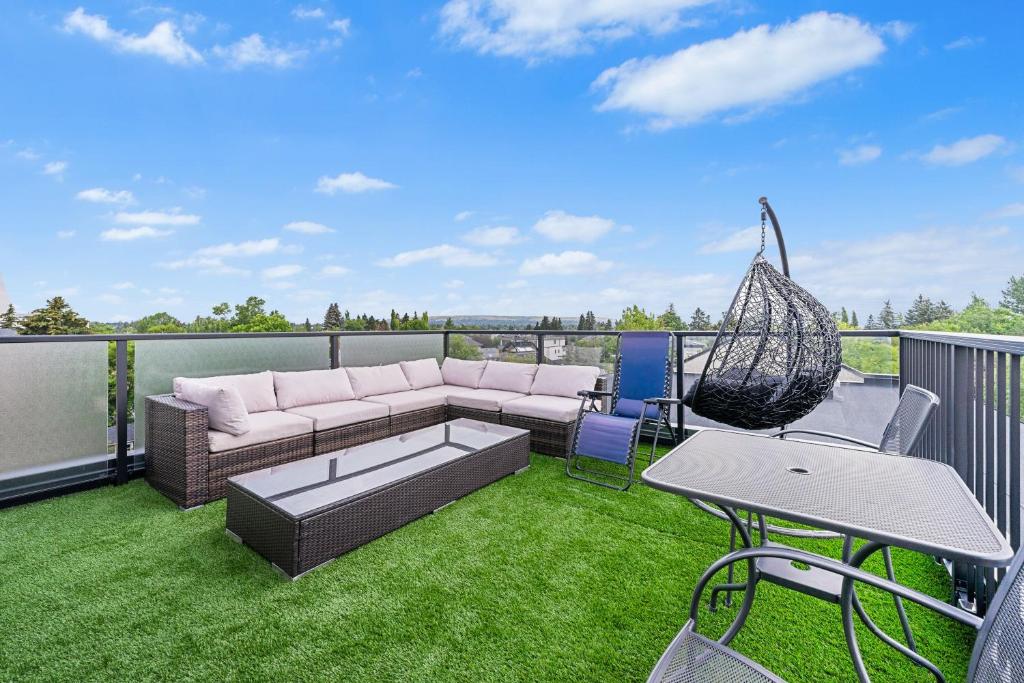 a patio with a couch and a hammock on a balcony at Casa Ladrillo - House of Bricks in Calgary
