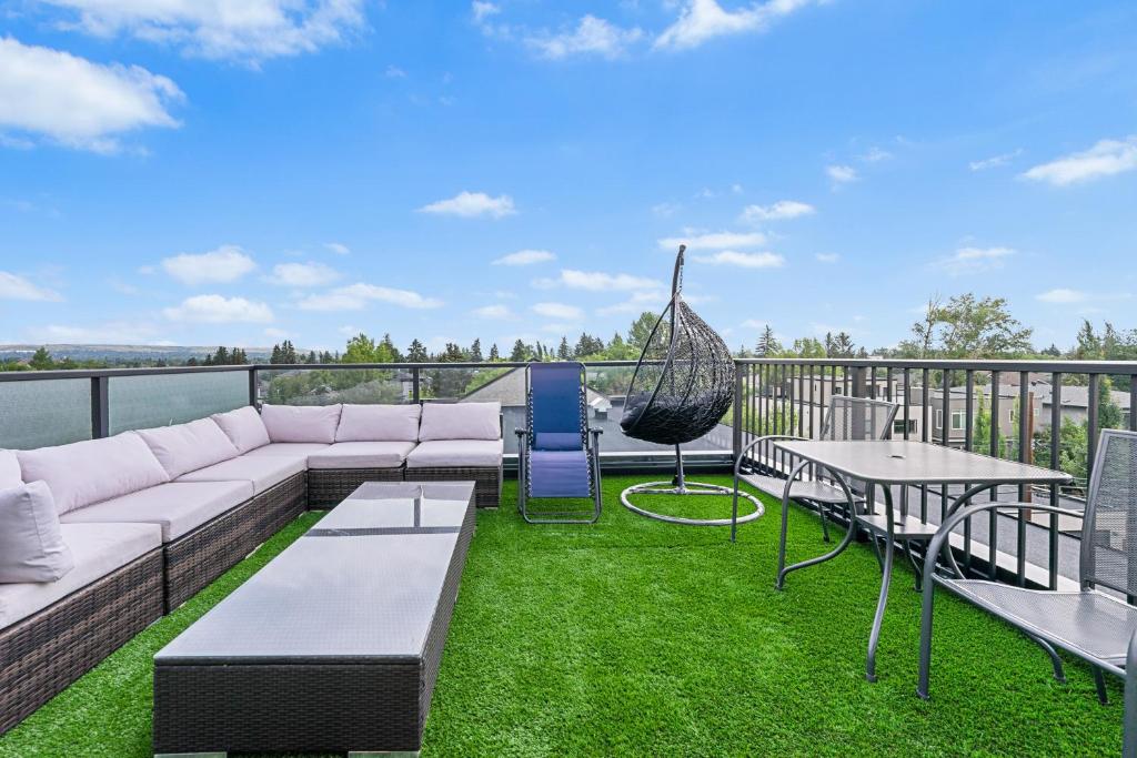 a patio with a couch and a hammock on a balcony at Casa Ladrillo - House of Bricks in Calgary
