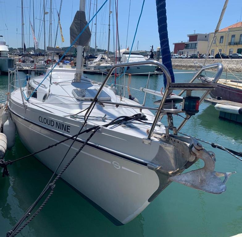 a white boat is docked in a harbor at Vintage sailboat experience in Lisbon
