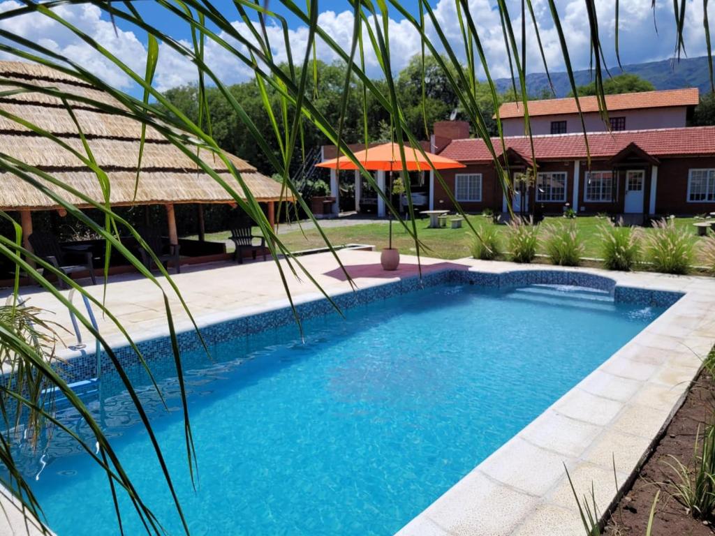 a swimming pool in front of a house at Nuova Costa Cabañas in Los Molles
