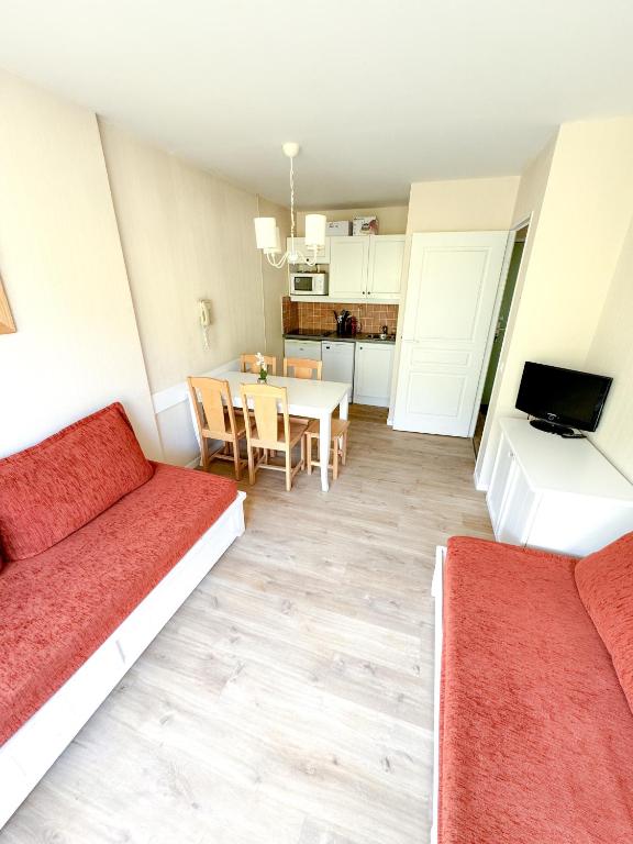 un salon avec deux lits et une table dans l'établissement Valmeinier, à Valmeinier