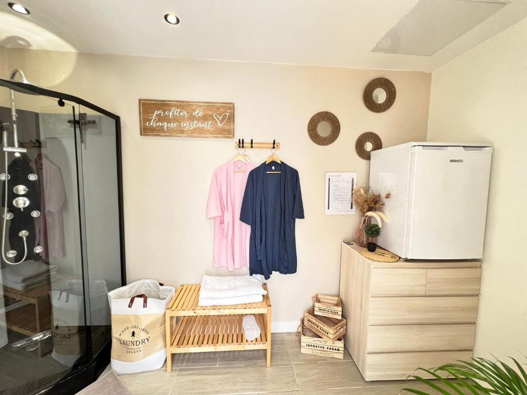 a room with a refrigerator and a shelf at LOVE ROOM Tente Lodge spa MFG chez C&C, exclusivement réservée aux ADULTES in Cantaron