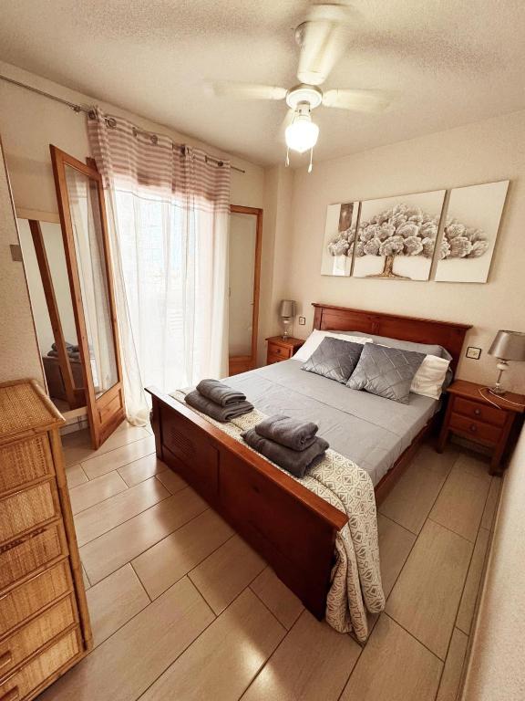a bedroom with a bed with two towels on it at APARTAMENTOS ROSI - 5-10 Minute Walk To La Zenia Beach, Sea View, Beach Bar, Cliff Walk, Shops, Paddys Point, Cabo Roig - Free fast Fibre Optic Broadband, Free Parking, Tassimo coffee machine, TV Firestick compatible in Playas de Orihuela
