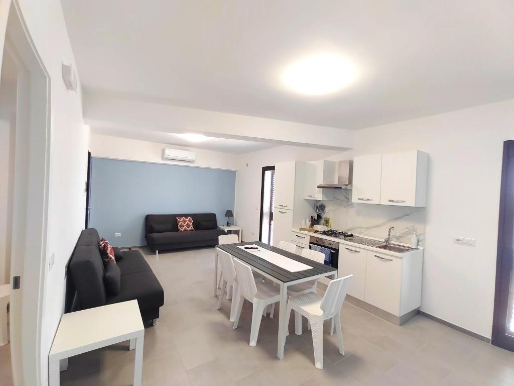 a living room with a couch and a table and a kitchen at Casa Borgo Antico Cavallaro in Gaggi