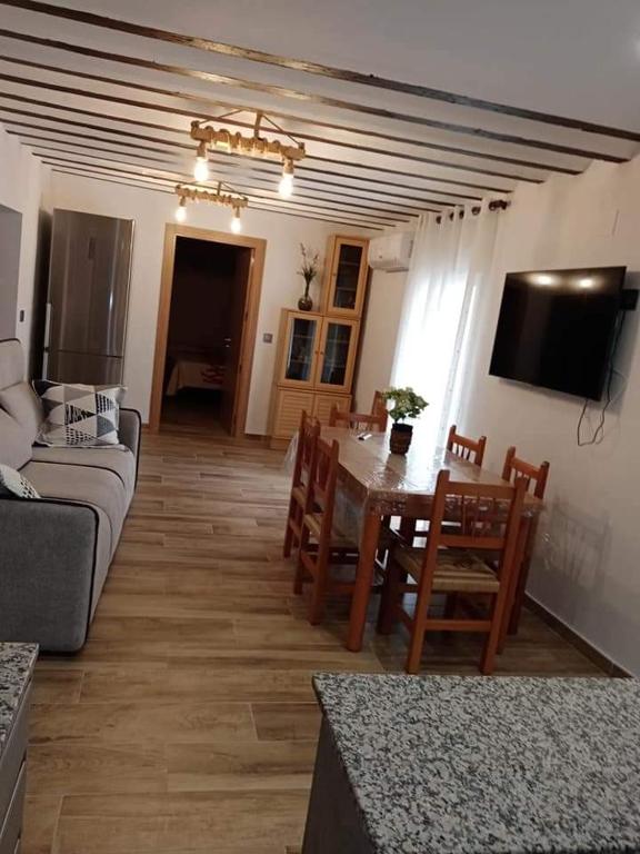 a living room with a table and a couch at Casa Soro Ayna in Ayna