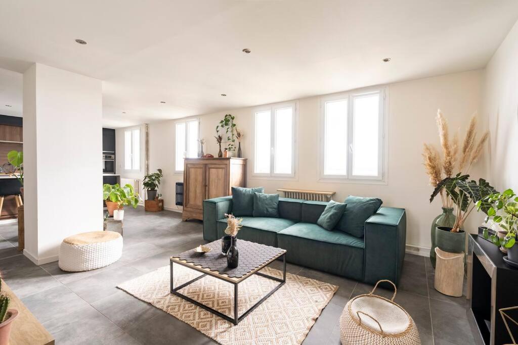 un salon avec un canapé bleu et une table dans l'établissement Le Skyview - Vue sur Lyon, à La Mulatière