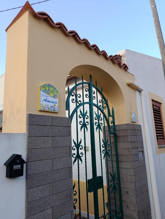 a gate on the side of a building at Casa Amena con ampio terrazzo e giardino in Lipari