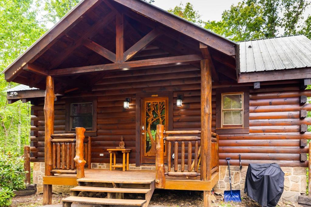a log cabin with a porch and a door at Charming 2BR Cabin with Hot Tub & Mountain Views in Sevierville