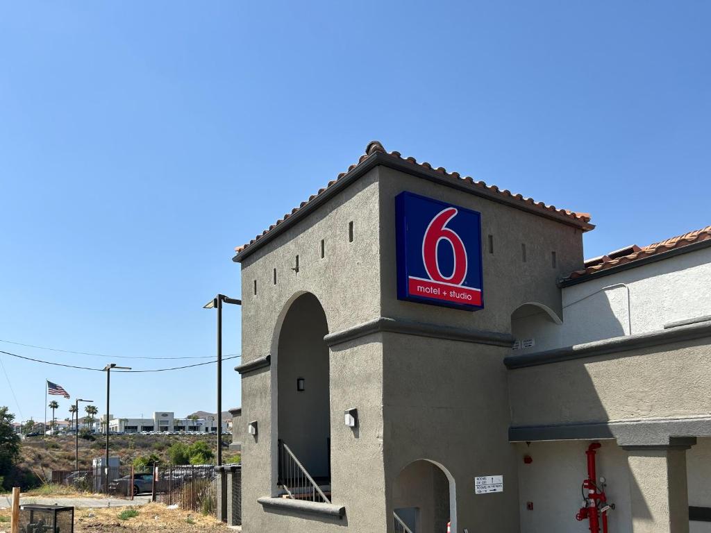 a pepsi sign on the side of a building at Studio 6 Lake Elsinore, CA in Lake Elsinore