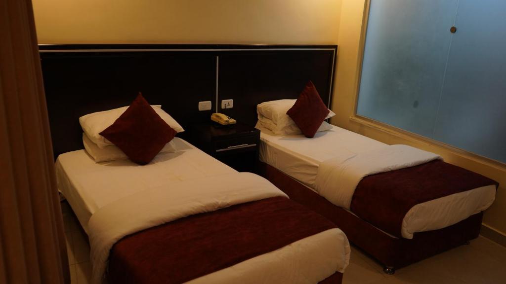 Postel nebo postele na pokoji v ubytování petra agora hotel