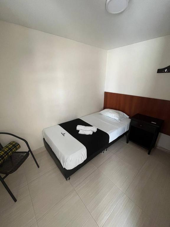Postel nebo postele na pokoji v ubytování HOTEl OTUN PLAZA PEREIRA