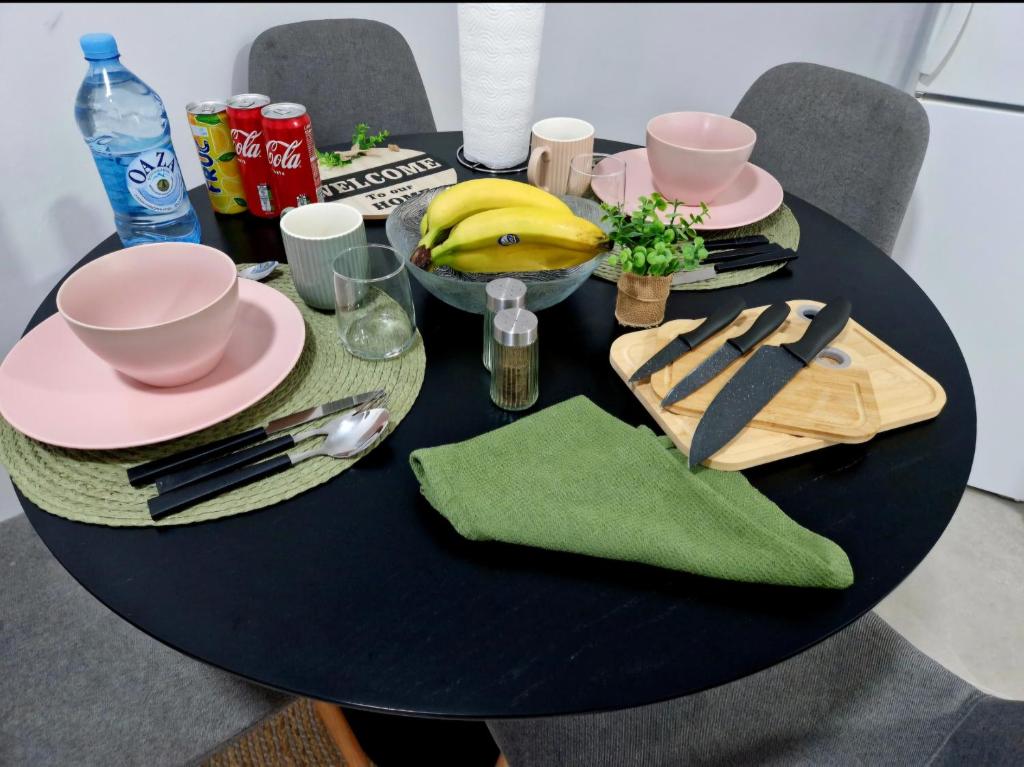 a black table with a plate and a banana on it at Infinity Apartment & Free Wifi & Free Parking in Sarajevo
