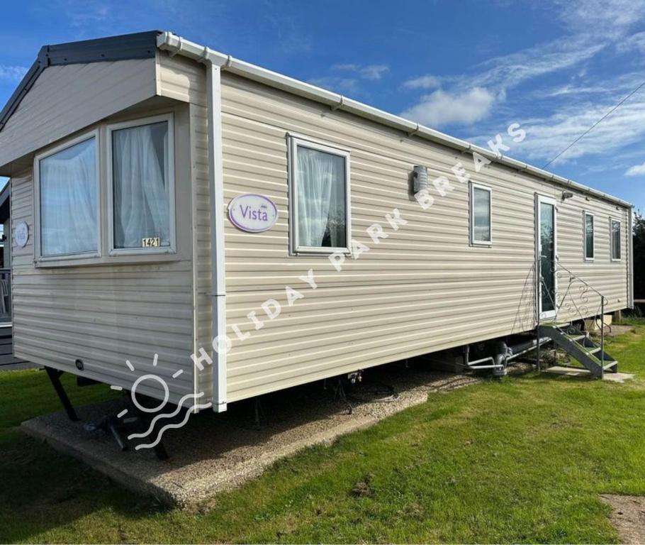 a silver trailer is parked in a yard at Driftwood - Bronze 3 bedroom West Sands Sleeps 8 in Selsey