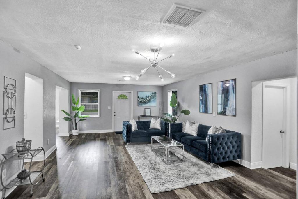 a living room with a blue couch and a table at Luxury Miami Retreat in North Miami
