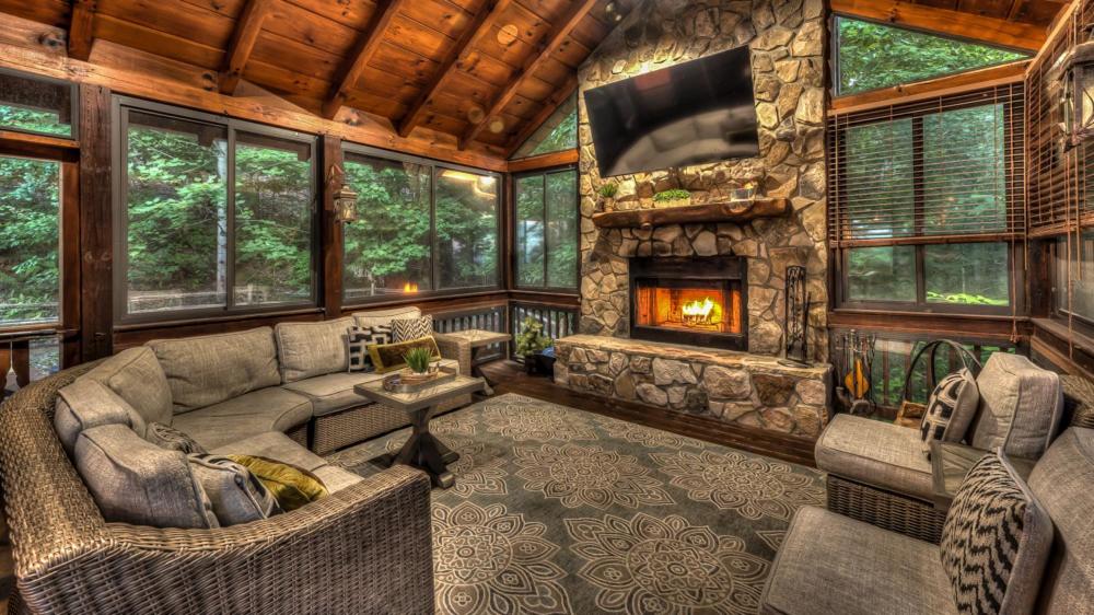 een woonkamer met een bank en een open haard bij Knotty By Nature in Blue Ridge