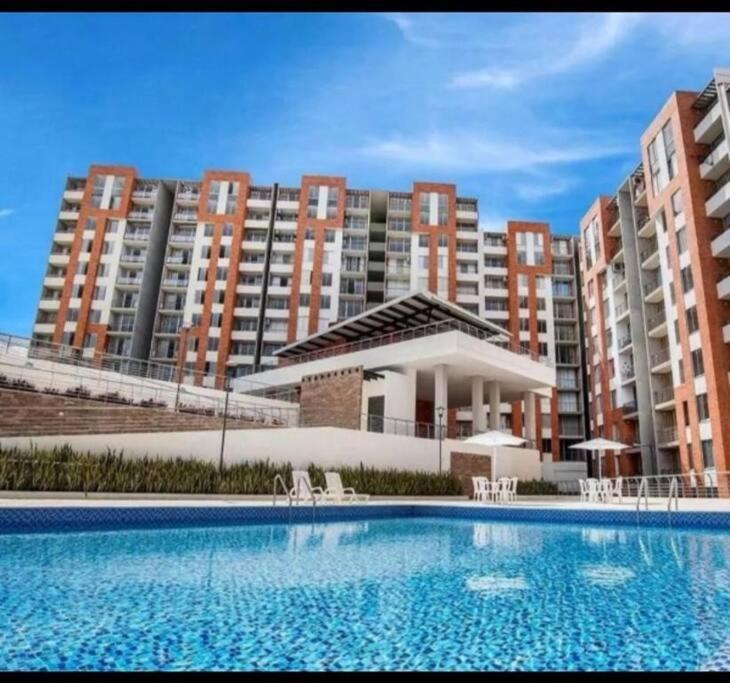 a large swimming pool in front of some tall buildings at Apartamento Casa Garzon in Girardot