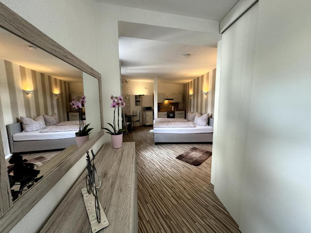 a room with two beds and a mirror at Stadtzauber in Malchow