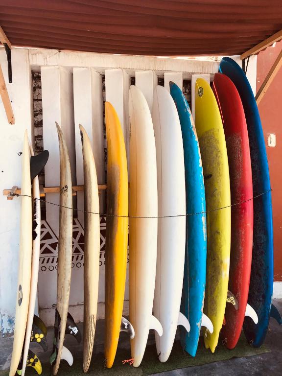 a bunch of surfboards hanging on a wall at Pointbreak Surf Camp in Huanchaco