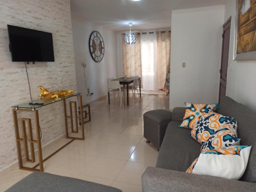a living room with two couches and a tv at Apartamento en Ciudad Juan Bosch in La Javilla