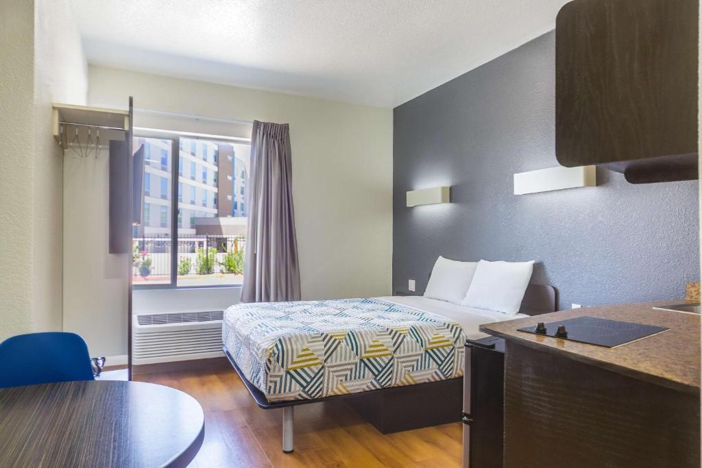 a hotel room with a bed and a window at Motel 6-Laredo, TX - Airport in Laredo