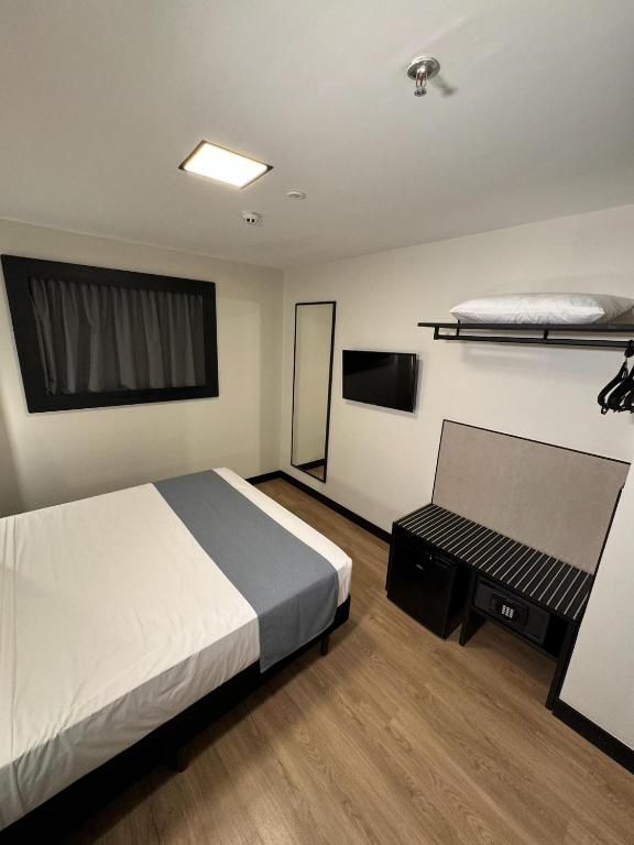 Postel nebo postele na pokoji v ubytování WA HOTEL FORTALEZA