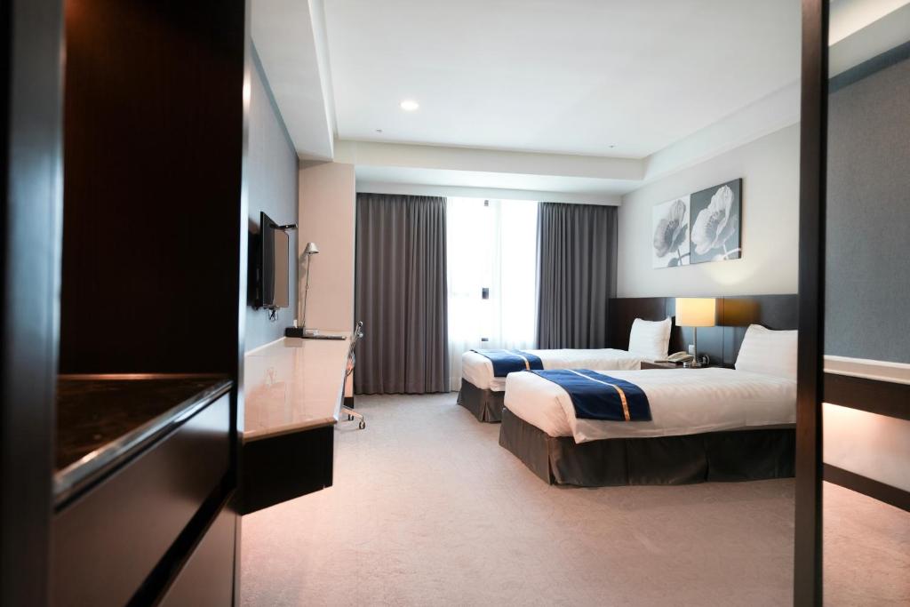 Postel nebo postele na pokoji v ubytování HiYesHotel勤天商旅-花蓮館