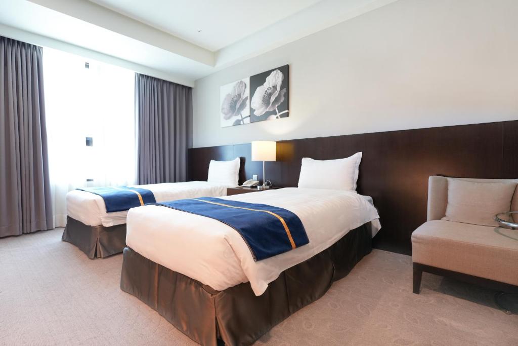 Postel nebo postele na pokoji v ubytování HiYesHotel勤天商旅-花蓮館