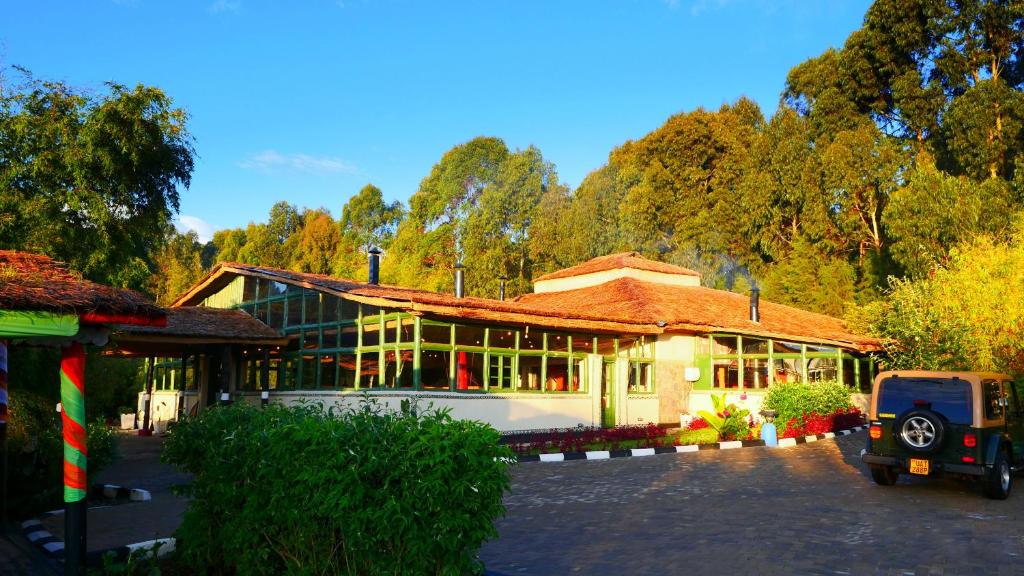 a building with a car parked in front of it at Le Bambou Gorilla Lodge in Ruhengeri