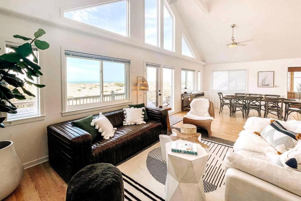 a living room with a couch and a table at Dune Haus - Oceanfront w Hot Tub, Private Beach in Salvo
