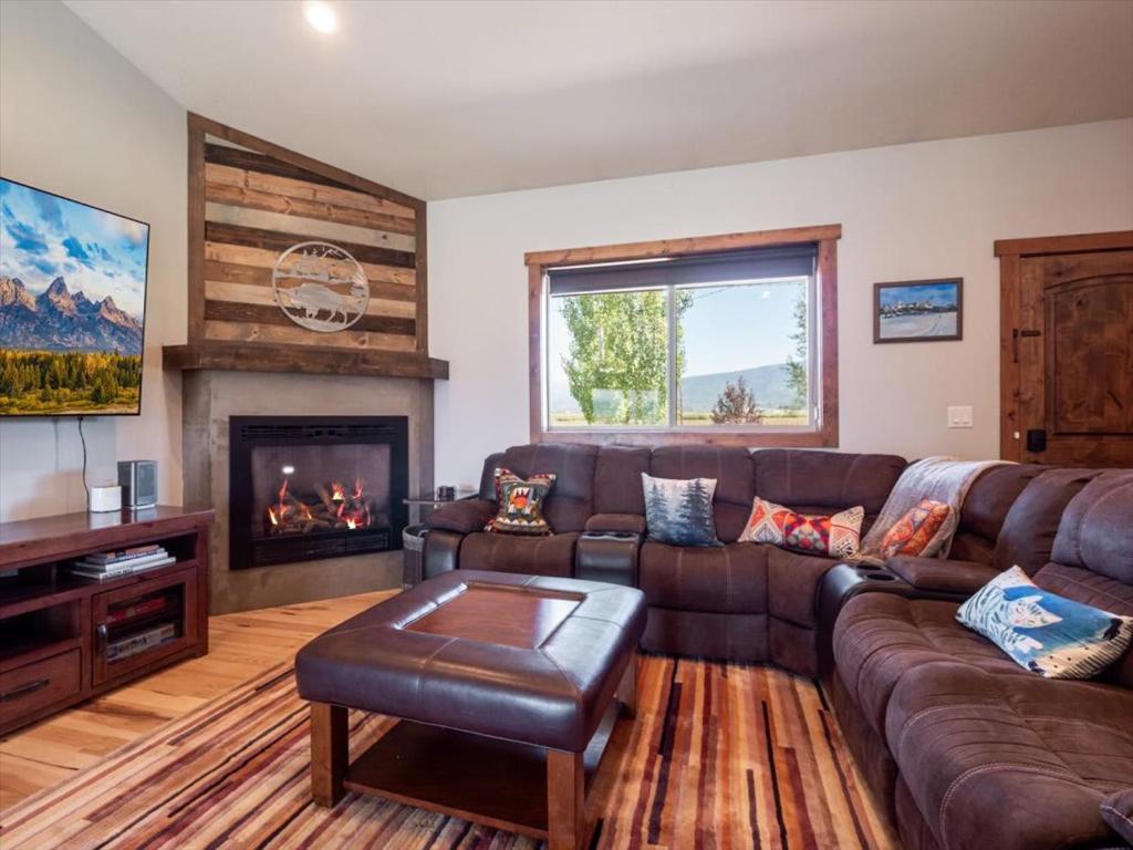 a living room with a couch and a fireplace at Targhee & Teton Getaway in Driggs