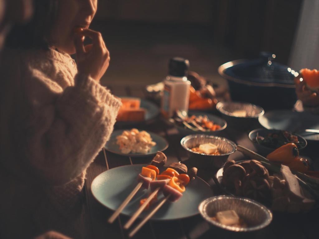 a woman talking on a cell phone next to plates of food at Seage Torami Coastside in Ichinomiya