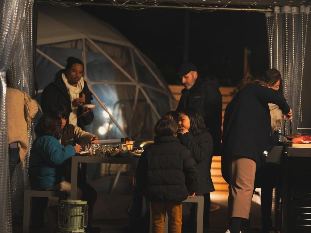 a group of people standing around a table with wine glasses at Seage Torami Coastside in Ichinomiya