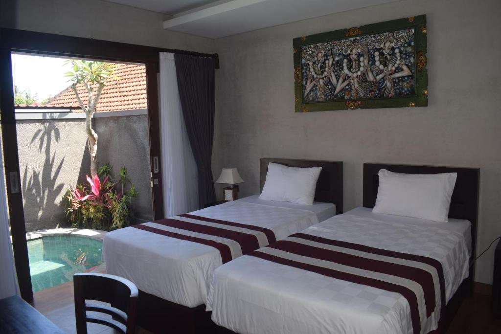 Postel nebo postele na pokoji v ubytování Werkudara Guest House
