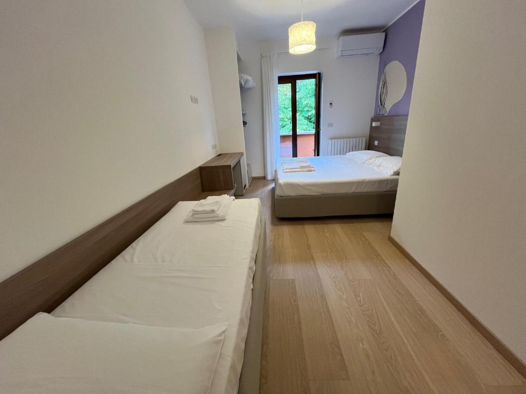 Postel nebo postele na pokoji v ubytování Hotel Al Pescatore