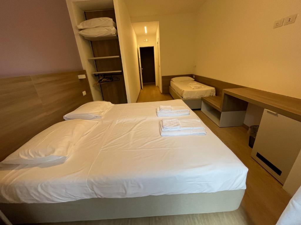 Postel nebo postele na pokoji v ubytování Hotel Al Pescatore