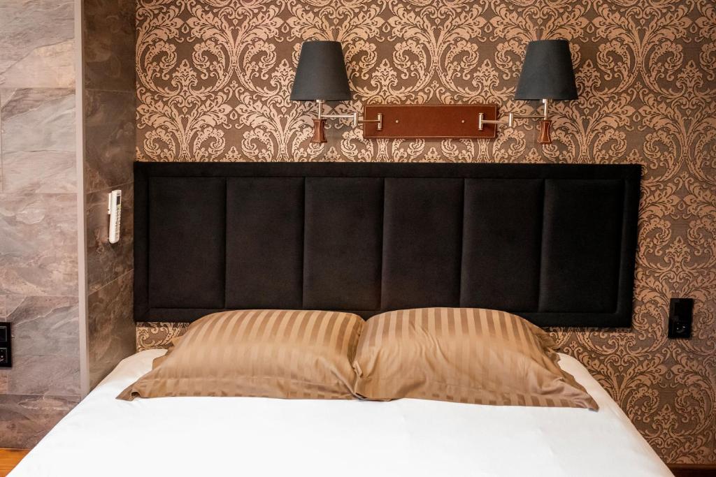 Postel nebo postele na pokoji v ubytování Enika Hotel