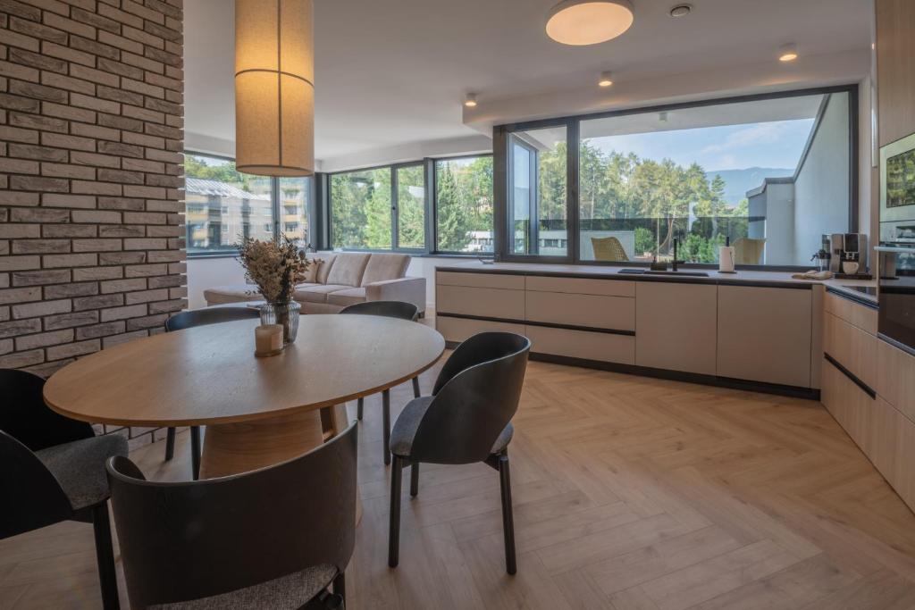 Una cocina y un comedor con mesa y sillas. en Rezidencia Galéria, en Ružomberok